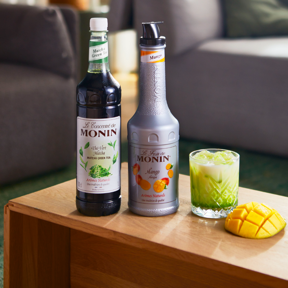 Monin Premium Matcha Concentrate (1 Litre) with a Bottle of Monin Mango Puree and a glass with an Iced Matcha Mango Drink - Discount  Coffee