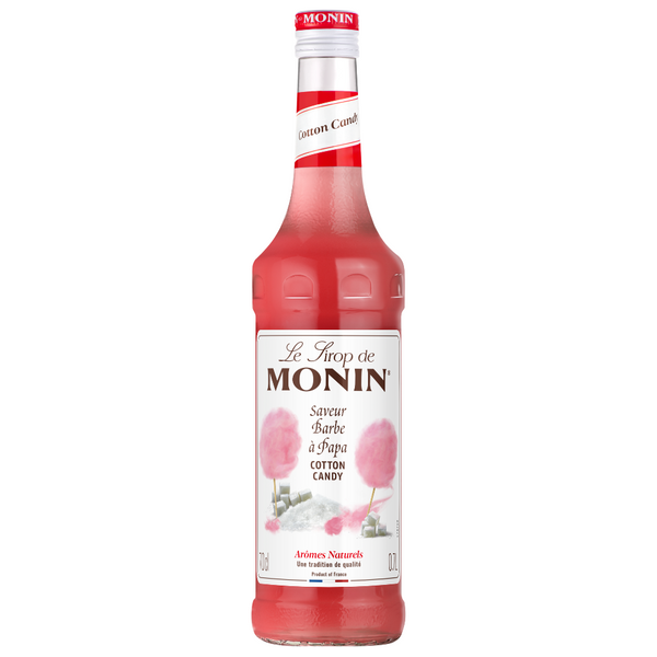 A 700ml bottle of Monin Cotton Candy syrup, featuring a vibrant pink liquid and a white label with pink cotton candy illustrations, set against a plain white background.