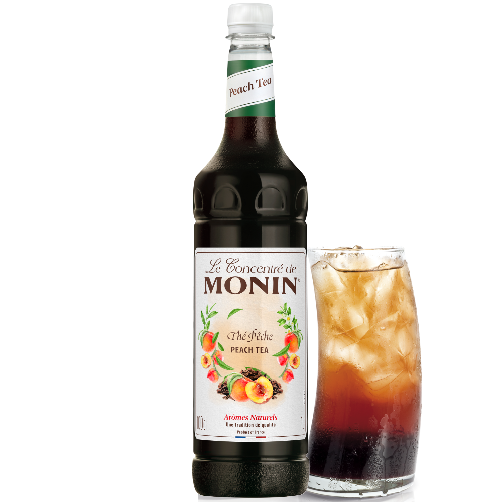 Monin peach tea syrup bottle 1 Litre with a glass of iced peach tea on a white background - Discount Coffee