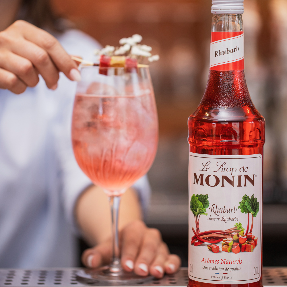 Monin Rhubarb Syrup (700ml) Wine Glass Containing an Iced Rhubarb Spritzer - Discount Coffee