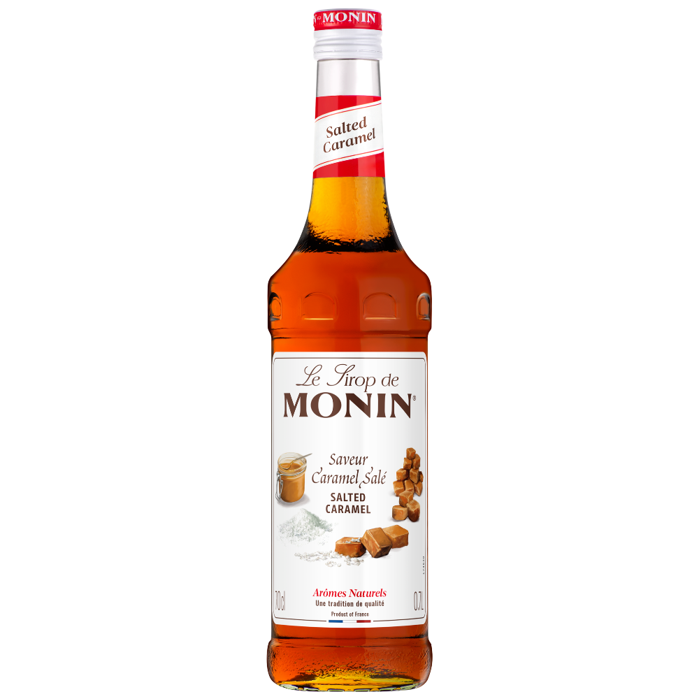 A bottle Monin Salted Caramel syrup 700ml, featuring a white label with brown caramel illustrations and a red cap, set against a plain white background.