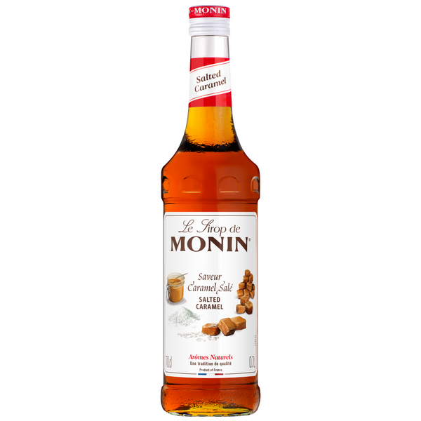 A bottle Monin Salted Caramel syrup 700ml, featuring a white label with brown caramel illustrations and a red cap, set against a plain white background.